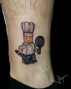 a small chef tattoo on the ankle