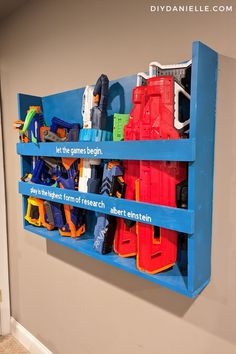 a blue shelf filled with toys on top of a wall