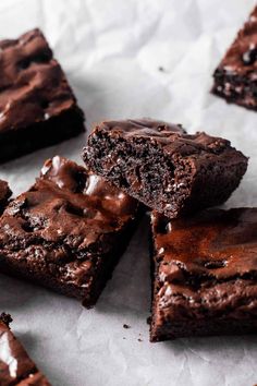 chocolate brownies are stacked on top of each other with one bite taken out of it