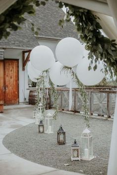 some white balloons and lanterns on the ground