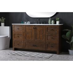 a white toilet sitting next to a wooden vanity