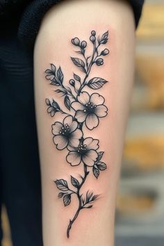 a black and white flower tattoo on the leg