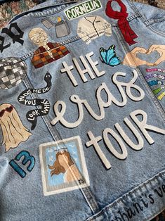 a jean jacket with the words the erase tour written on it and various stickers