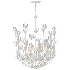 a chandelier with white flowers hanging from it's center point and two lights on each side