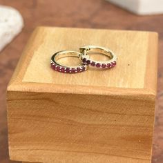 10KT yellow gold genuine ruby huggie hoop earrings. Ruby is the birthstone for July Babies! Also available in emerald. Length: 8mm Diameter: 8mm Thickness: 1.5mm Weight: 1.03 grams Stamped 10K 10K solid gold Latch backs One pair (16) 1.5mm genuine, prong set, round rubies Can also do in ruby Fine Jewelry Stackable Earrings As Gift, Fine Jewelry Stackable Earrings For Gift, 14k Gold Stackable Huggie Earrings As A Gift, Stackable Yellow Gold Earrings For Gift, Stackable Round Huggie Earrings For Anniversary, Stackable Huggie Earrings Fine Jewelry For Gift, Stackable Huggie Earrings As Gift In Fine Jewelry, Anniversary Stackable Huggie Hoop Earrings, 14k Gold Huggie Earrings With Gemstone