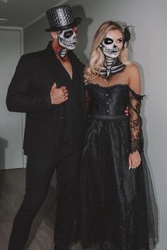 a man and woman dressed up in skeleton makeup