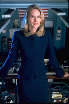 a woman in a blue suit posing for the camera