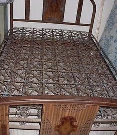 an old metal bed with wooden headboard and foot board