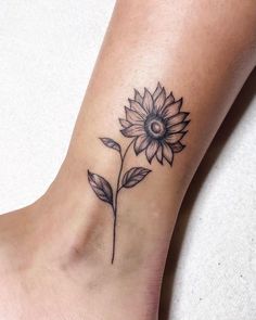 a small sunflower tattoo on the ankle