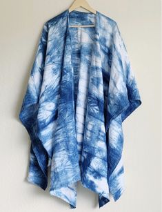 a blue and white tie - dyed kimono hanging on a wall