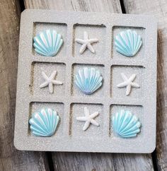 an ice tray with seashells and starfish on it