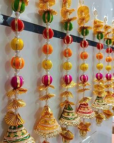 many different colored ornaments hanging on a wall