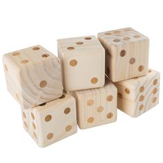 several wooden dices stacked on top of each other with gold polka dot dots in them