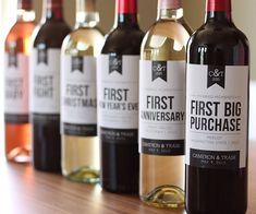 five bottles of wine are lined up on a table with the label first big purchase