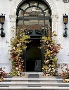 an entrance to a building with flowers on the steps