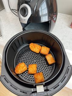 some fried food is being cooked in an air fryer