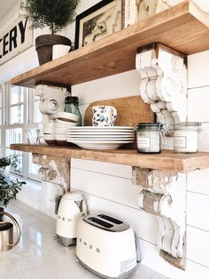 the shelves in this kitchen are filled with dishes