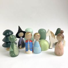 a group of wooden toy figurines sitting next to each other