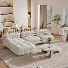 a living room filled with white couches and tables