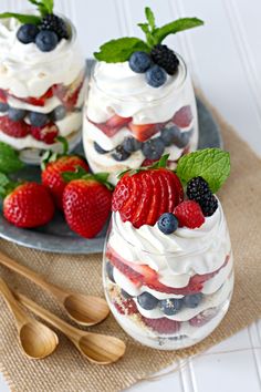 two desserts with strawberries, blueberries and raspberries in them