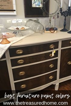 the dresser is painted brown and white with gold hardware on it's drawers, along with other decorative items