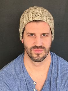 a man with a beard wearing a knitted hat