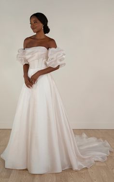 Style 7940 is an on-trend puffy sleeve wedding gown that exudes pure sophistication and cosmopolitan glamour. The pearl organza ballgown wedding dress features detachable off-the-shoulder puff sleeves that complement the length of the bodice—covering the mid-upper arm to the elbow. A gorgeously draped strapless bodice features a straight across neckline with structured corset boning to support the form and draw the eye to the natural hourglass figure.   This wedding gown is also available in plus sizes. Puff Sleeve Floral Wedding Dress, Poet Sleeve Wedding Dress, Organza Wedding Dress Ballgown, Puffy Sleeve Wedding Dress, Wedding Dress With Puffy Sleeves, Wedding Dress Fishtail, Puff Sleeve Wedding Dress