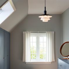 a bedroom with a bed, dresser and window