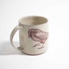 a coffee cup with a bird drawn on it