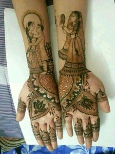 two hands with henna designs on them