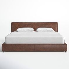 a bed with white sheets and brown leather headboard