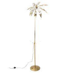 a floor lamp with a metal base and a palm tree on top