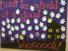 a bulletin board with ghost decorations on it and words written in the background that read don't be afraid of a good book