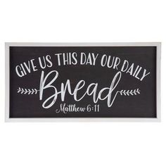 a black and white sign with the words give us this day our daily bread written on it