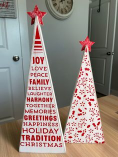 two wooden christmas trees sitting on top of a table