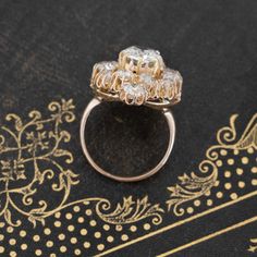 This gorgeous cluster ring fell into our laps and we haven’t stopped staring at her since! With a 1.52ct center, this baby is surrounded by old mines, each sitting in its’ own buttercup mounting. With two more diamonds sitting at the north and south points, it all makes for one of the more unique clusters we’ve found as of late! Airy yet bold, and most definitely sparkly.14kt yellow gold, size 5.75 & fully resizable.Diamond Measures: 7.29 x 6.88 x 3.20 mmGIA Link HereSurrounding diamonds are est Heirloom Cluster Ring Gift, Victorian Style Diamond Cluster Ring, Victorian Cluster Ring For Wedding, Heirloom Style Flower Ring With Brilliant Cut, Victorian Cluster Ring With Prong Setting, Victorian Cluster Ring For Anniversary, Heirloom Flower Ring With Prong Setting, Modern Mens Rings, Art Jewelry Earrings