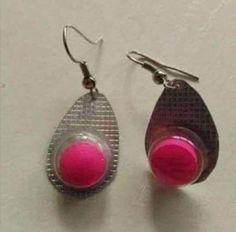 two pairs of earrings with pink beads on them