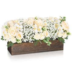 a wooden box filled with white flowers and greenery