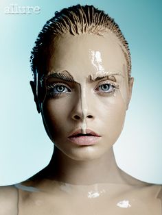 a woman's face is covered in plastic and the image appears to have been altered