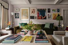 a living room filled with lots of furniture and pictures on the wall above it's coffee table