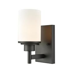 a wall light with a white glass shade on the front and back of it's arm