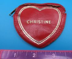 a red heart shaped case with the word pristinee written on it next to a ruler