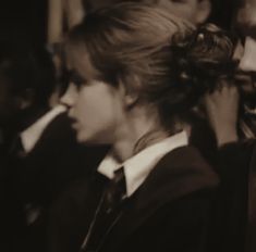 a group of young people standing next to each other in front of a crowd at a fashion show