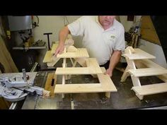 a man is making wooden furniture in his shop