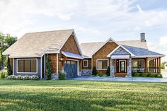 This visually aesthetic, one-level, country lake house plan features texture-rich shakes beneath gabled roof lines. The enormous, wrap-around, covered deck encompasses more than half of the home's exterior, with multiple access points. The open-concept floor plan greets you upon entering, presenting a fireplace with surrounding built-ins at one end, and a chef's kitchen at the other. The cathedral ceiling adds an elegant feature to the living space.Behind the kitchen, discover the master ... Country Style Bedroom, Lake Ideas, Healing Garden, Chef's Kitchen