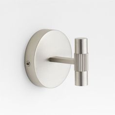 an image of a modern light fixture on the wall in white and stainless steel color