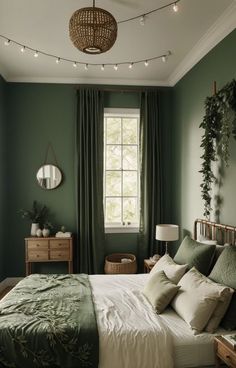 a bedroom with green walls and white bedding, lights strung from above the bed