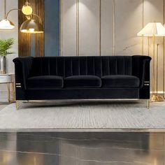 a black velvet couch sitting on top of a white rug