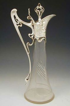 a glass vase with an ornate design on it