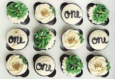 twelve cupcakes decorated with white frosting and green flowers are arranged in rows